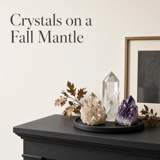 Citrine tower and a framed landscape on a wood mantel with dried stems