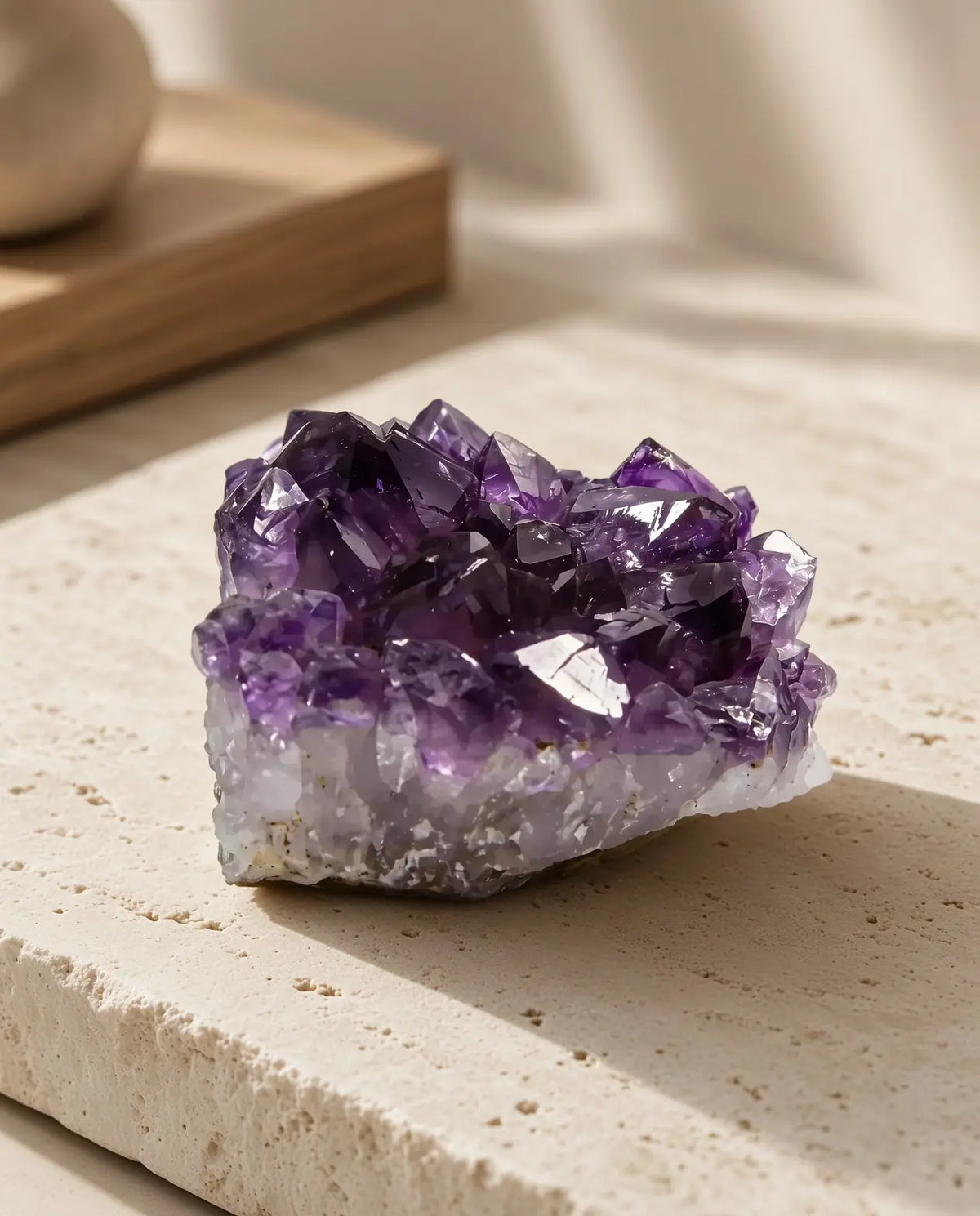 Amethyst crystal cluster displayed on a stone slab