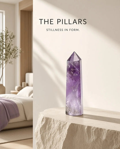 Obsidian crystal tower on a stone table with “The Pillars” brand text
