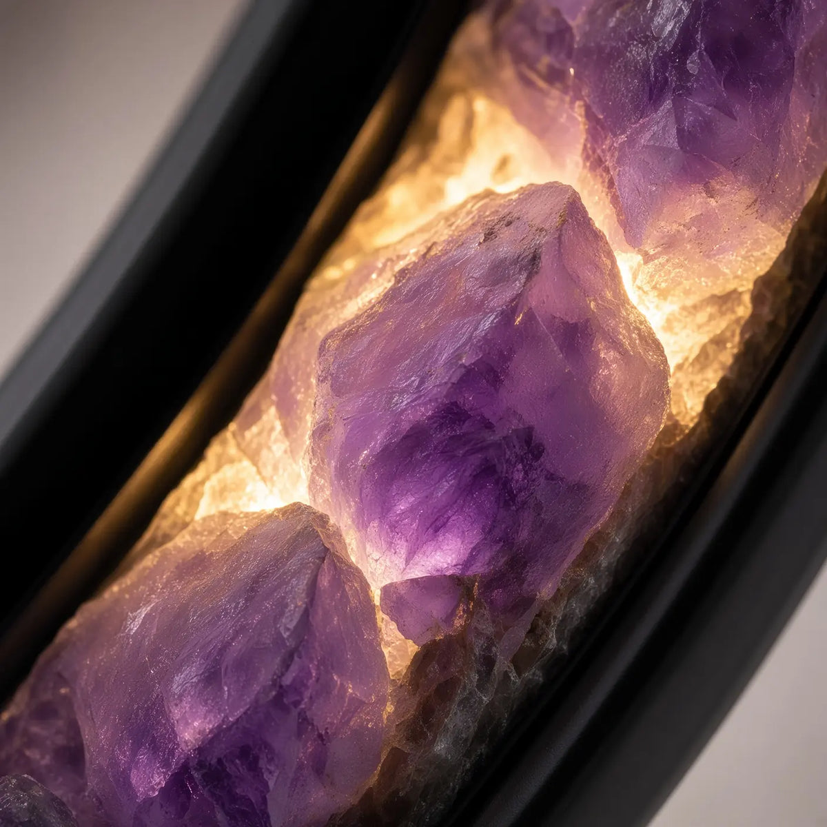 Close-up of glowing amethyst stones in the lamp