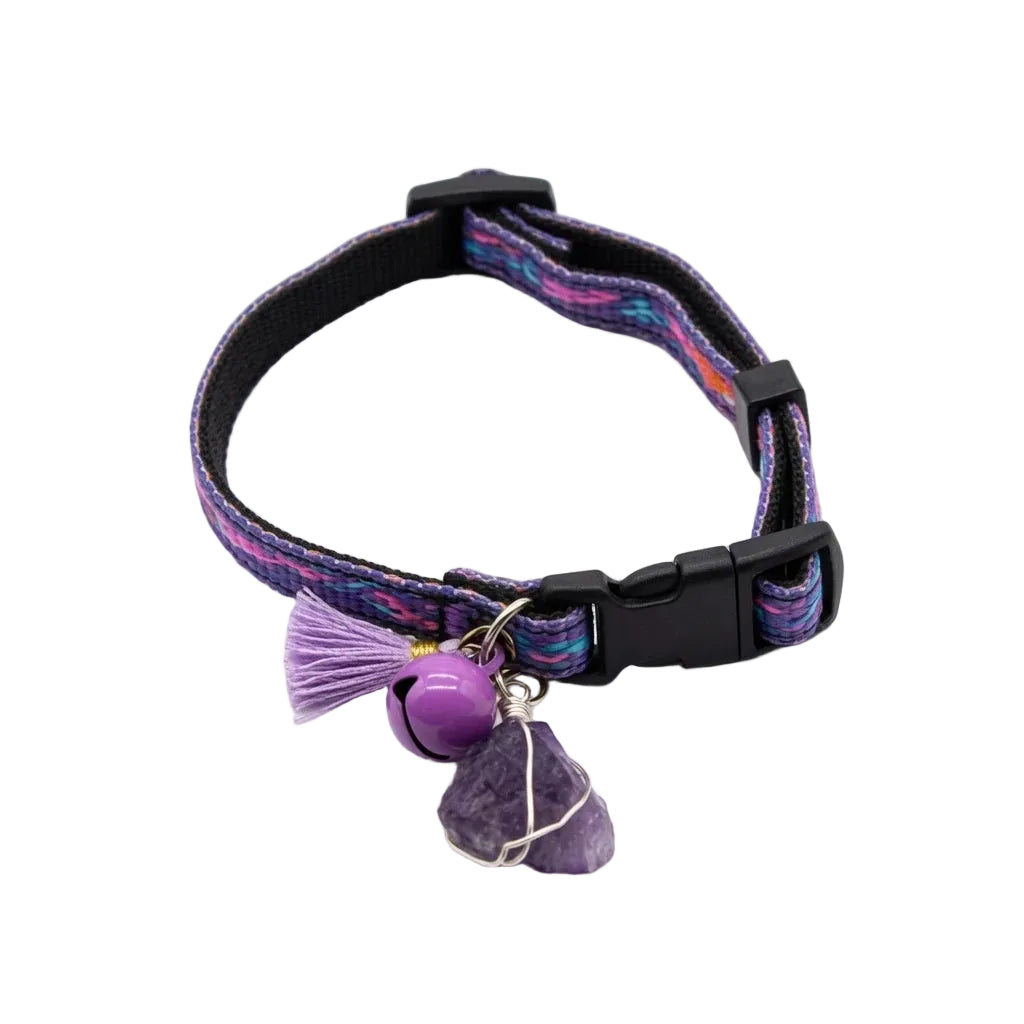 Purple bohemian geometric cat collar with wire-wrapped raw amethyst crystal charm, lavender tassel, purple bell, and cat-face safety breakaway buckle, healing crystal calming cat collar on white background