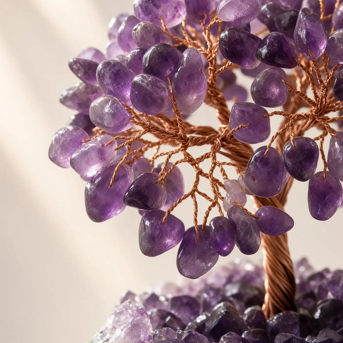 Detail of amethyst chips and copper wire branches on a crystal tree