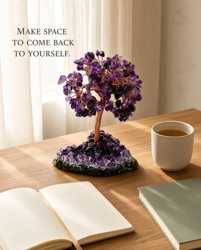 Amethyst crystal tree styled with tea and books on a wooden desk