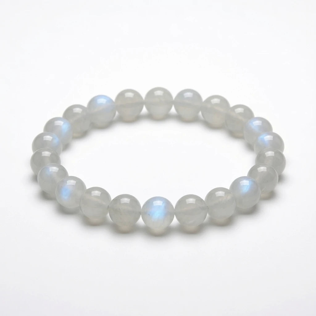Natural moonstone beaded bracelet with translucent milky white 8mm round stones showing blue adularescence sheen, healing crystal jewelry for new beginnings on white background