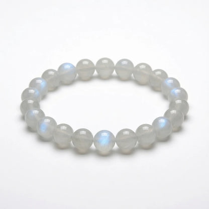 Natural moonstone beaded bracelet with translucent milky white 8mm round stones showing blue adularescence sheen, healing crystal jewelry for new beginnings on white background
