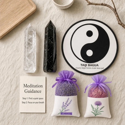 Balance Ritual Kit laid out: clear quartz and black obsidian towers, a yin-yang mat, a guidance card and two herb sachets