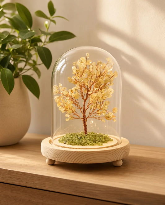 Citrine glow tree in a glass dome on a wooden table