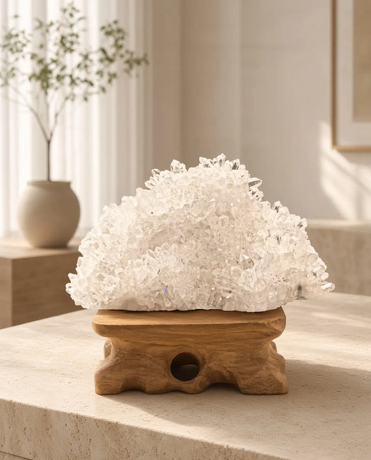 Clear quartz cluster sculpture on a wood stand
