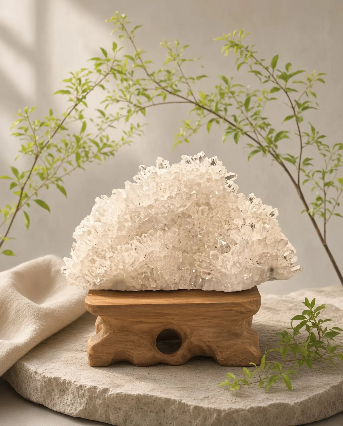 Clear quartz cluster sculpture styled with linen and greenery