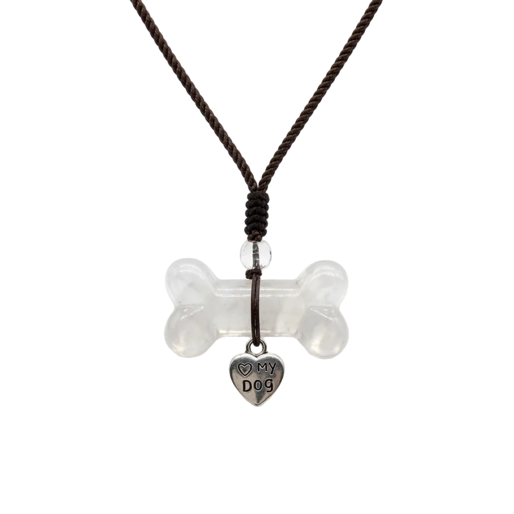 Natural clear quartz dog bone carved crystal pendant necklace with silver Love My Dog heart charm on adjustable brown braided cord, healing crystal jewelry for dog moms on white background