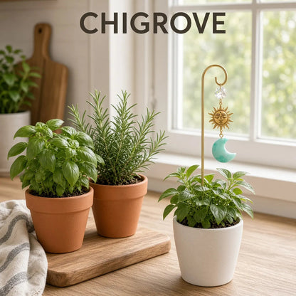 Green aventurine moon stake in a white herb pot, basil and rosemary on a wood board