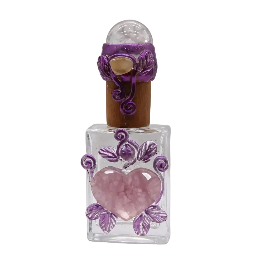 Handcrafted clear glass perfume bottle with rose quartz heart center, purple wire-wrapped leaf decoration, clear quartz sphere stopper and natural cork, healing ritual vessel on white background