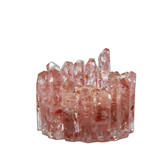 Handcrafted pink rose quartz resin crystal cluster charging bowl with citrine tower point displayed on wooden coffee table in warm living room setting