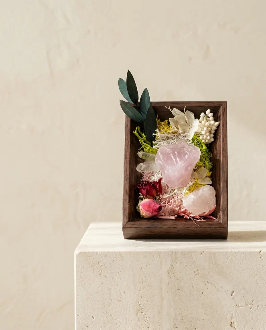 Rose quartz framed landscape with dried roses and eucalyptus in a dark wood box