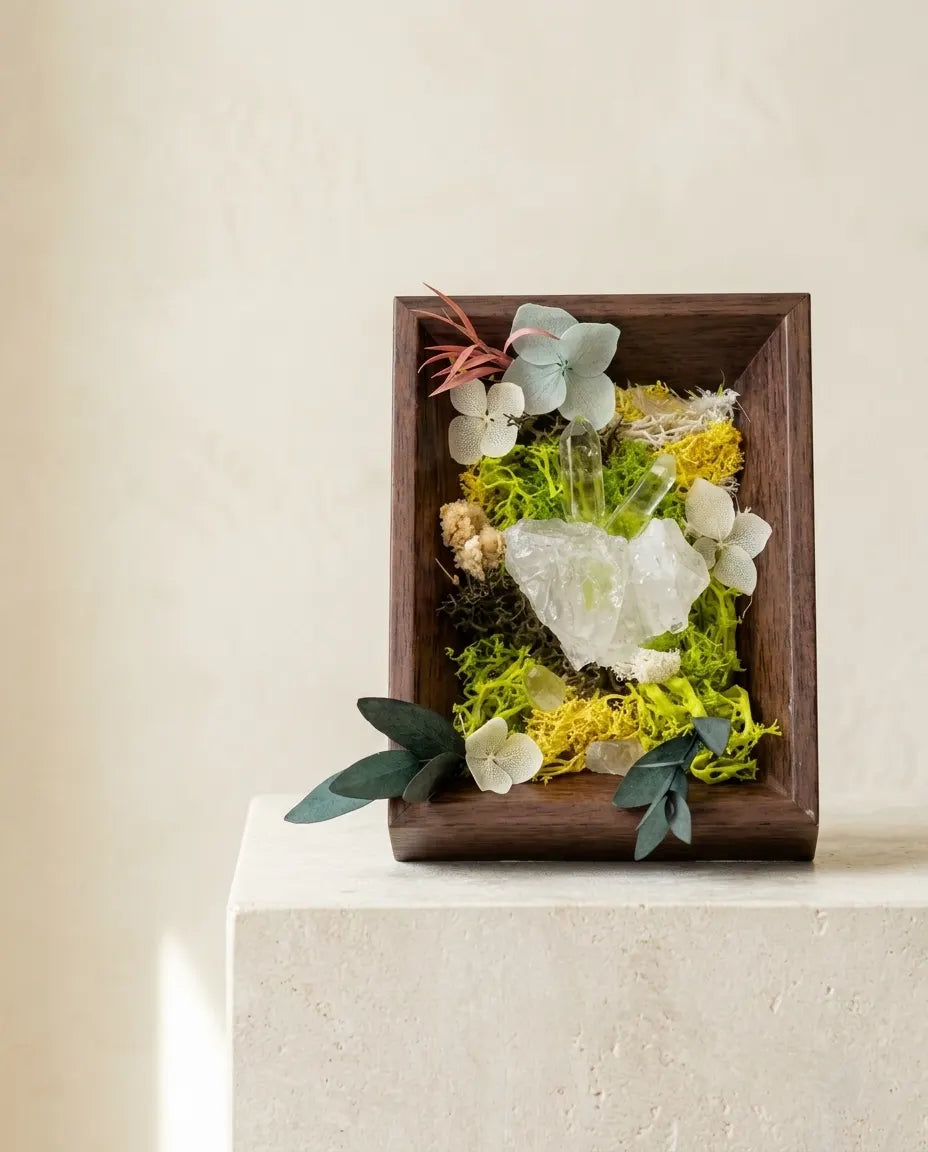 Clear quartz framed landscape with moss, quartz points and leaves in a dark wood box