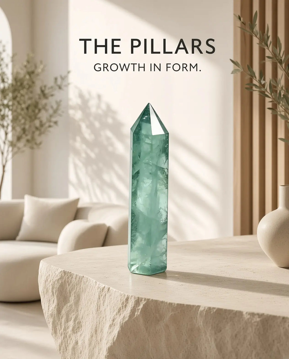 Green fluorite crystal tower on a stone table with “The Pillars” brand text