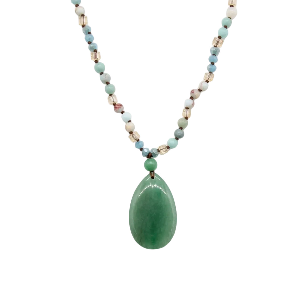 Green aventurine teardrop pendant on a beaded boho necklace, flat lay