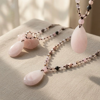 Close-up of polished pink rose quartz teardrop pendant