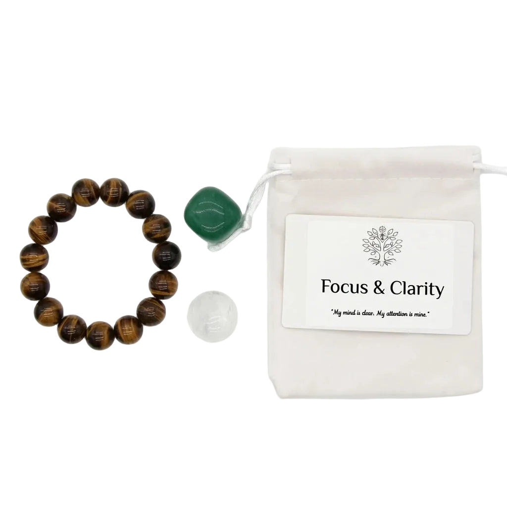 Focus and Clarity healing crystal gift set with tiger's eye beaded bracelet, tumbled green aventurine, tumbled clear quartz stones, affirmation card, and linen drawstring pouch on white background