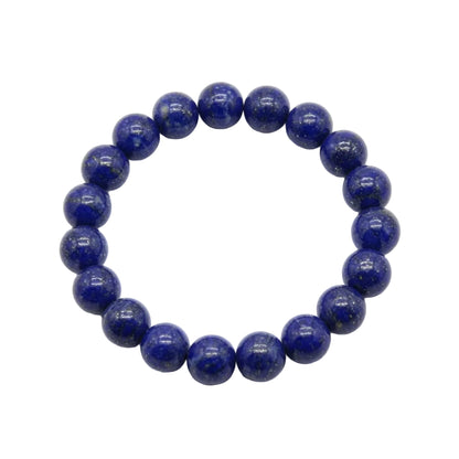Natural lapis lazuli beaded bracelet with deep royal blue 10mm round stones and golden pyrite inclusions laid flat on white background