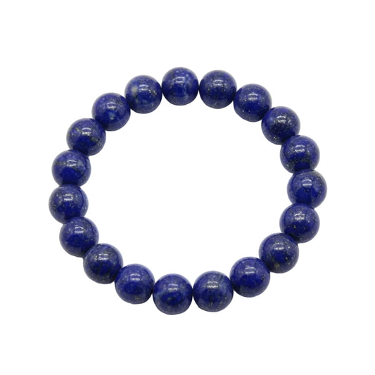 Natural lapis lazuli beaded bracelet with deep royal blue 10mm round stones and golden pyrite inclusions laid flat on white background