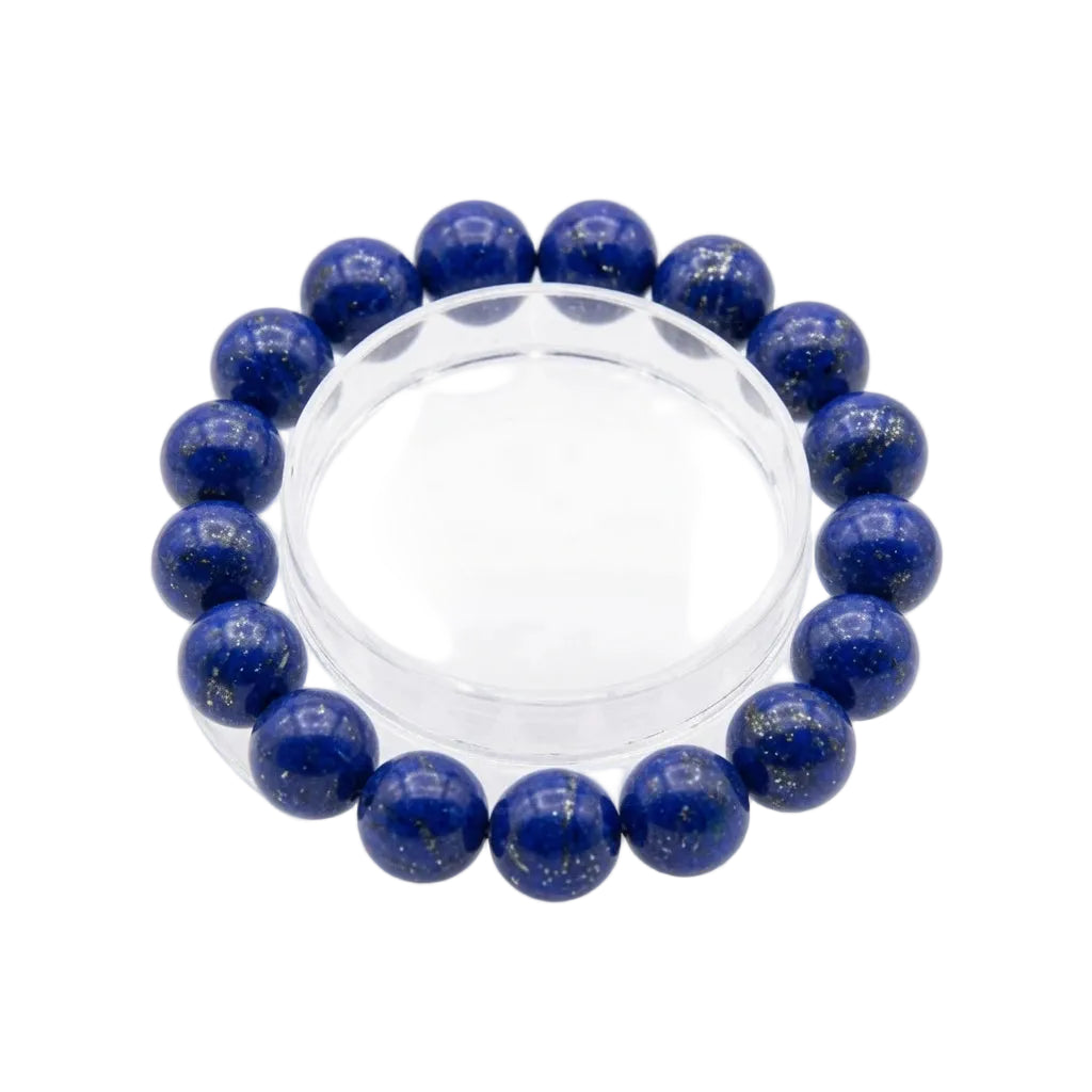
Close-up detail of natural lapis lazuli bracelet beads showing deep blue lazurite color with golden pyrite mineral inclusions and white calcite veining