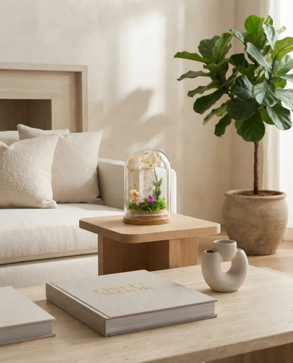 Clear quartz grove on a small oak side table in a living room with a sofa and fiddle-leaf fig