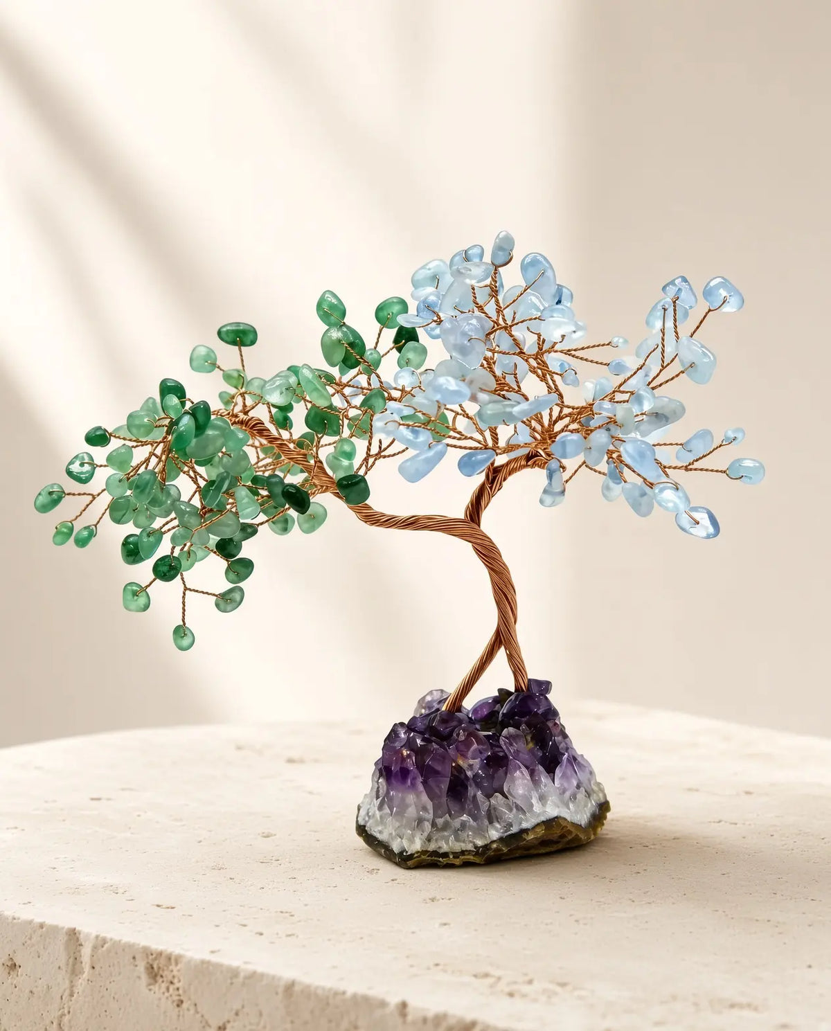 Rose quartz and aquamarine crystal tree on amethyst base displayed on stone