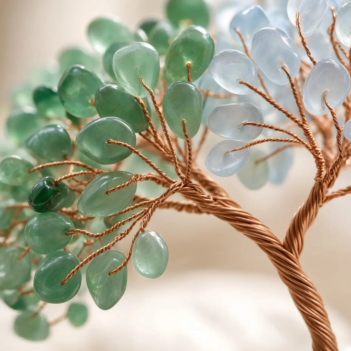 Detail of rose quartz and aquamarine chips on copper wire branches