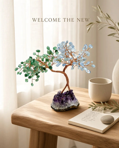 Rose quartz and aquamarine crystal tree styled with tea, journal and a flower