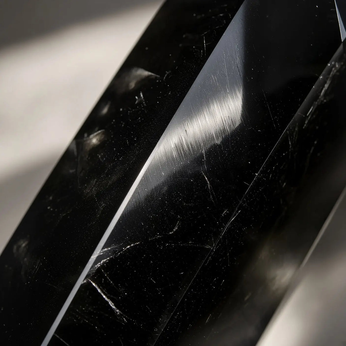 Close-up of obsidian crystal tower with glossy black facets