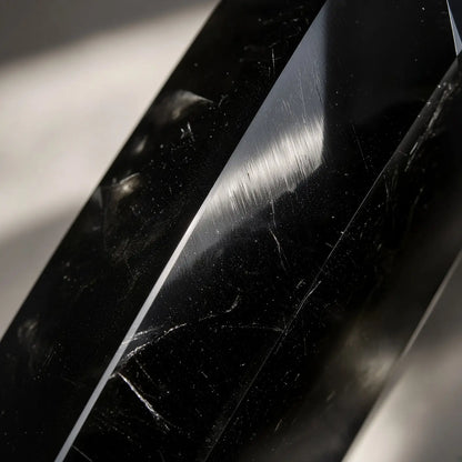Close-up of obsidian crystal tower with glossy black facets
