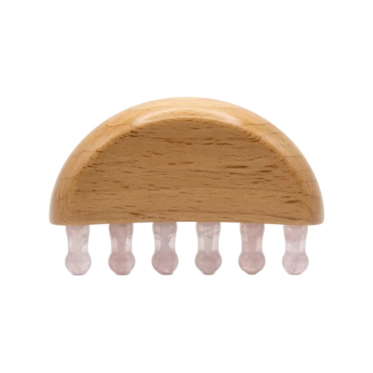 Natural rose quartz wide-tooth scalp gua sha comb with beechwood half-dome base and six pale pink crystal teeth, hair growth massage tool on white background