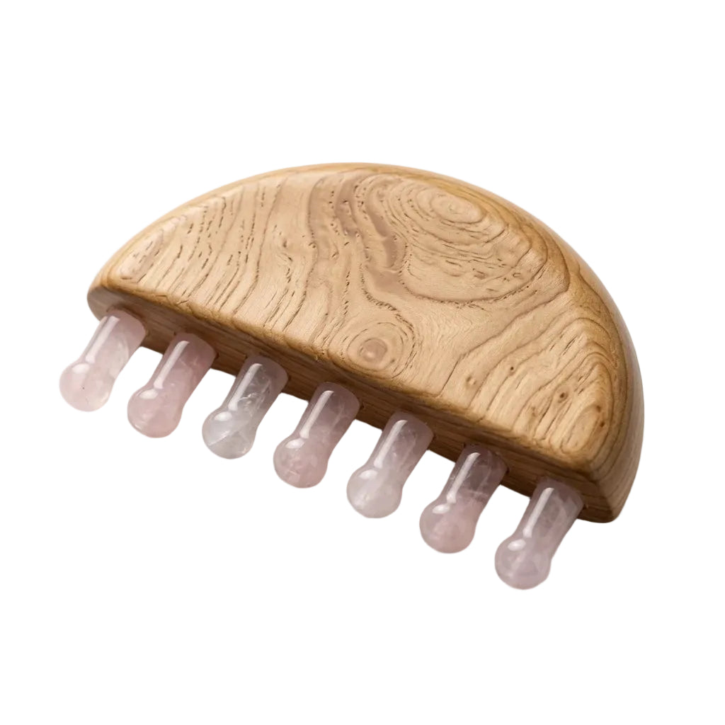 Natural rose quartz wide-tooth scalp gua sha comb with beechwood half-dome base and six pale pink crystal teeth, hair growth massage tool on white background