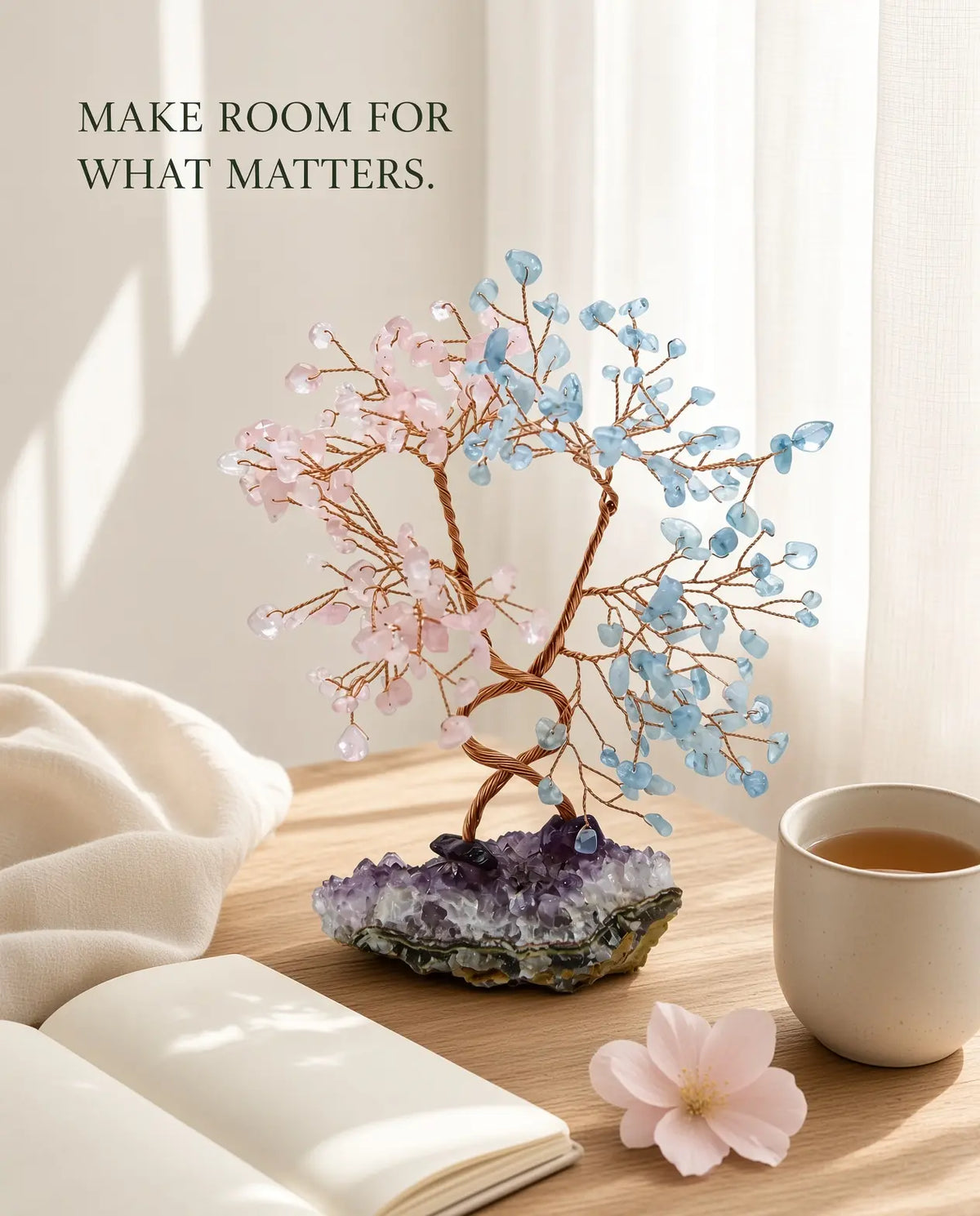 Rose quartz and aquamarine crystal tree styled with tea, journal and a flower