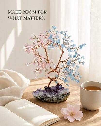 Rose quartz and aquamarine crystal tree styled with tea, journal and a flower
