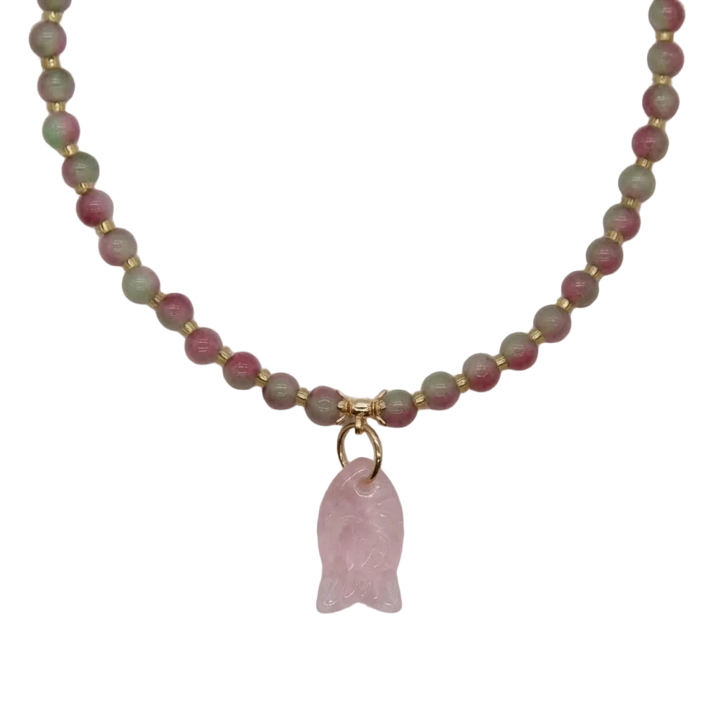 Close-up of carved rose quartz fish pendant and watermelon tourmaline pink-green crystal beads with gold spacers on cat collar necklace, natural healing gemstone detail