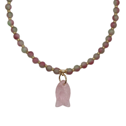 Close-up of carved rose quartz fish pendant and watermelon tourmaline pink-green crystal beads with gold spacers on cat collar necklace, natural healing gemstone detail