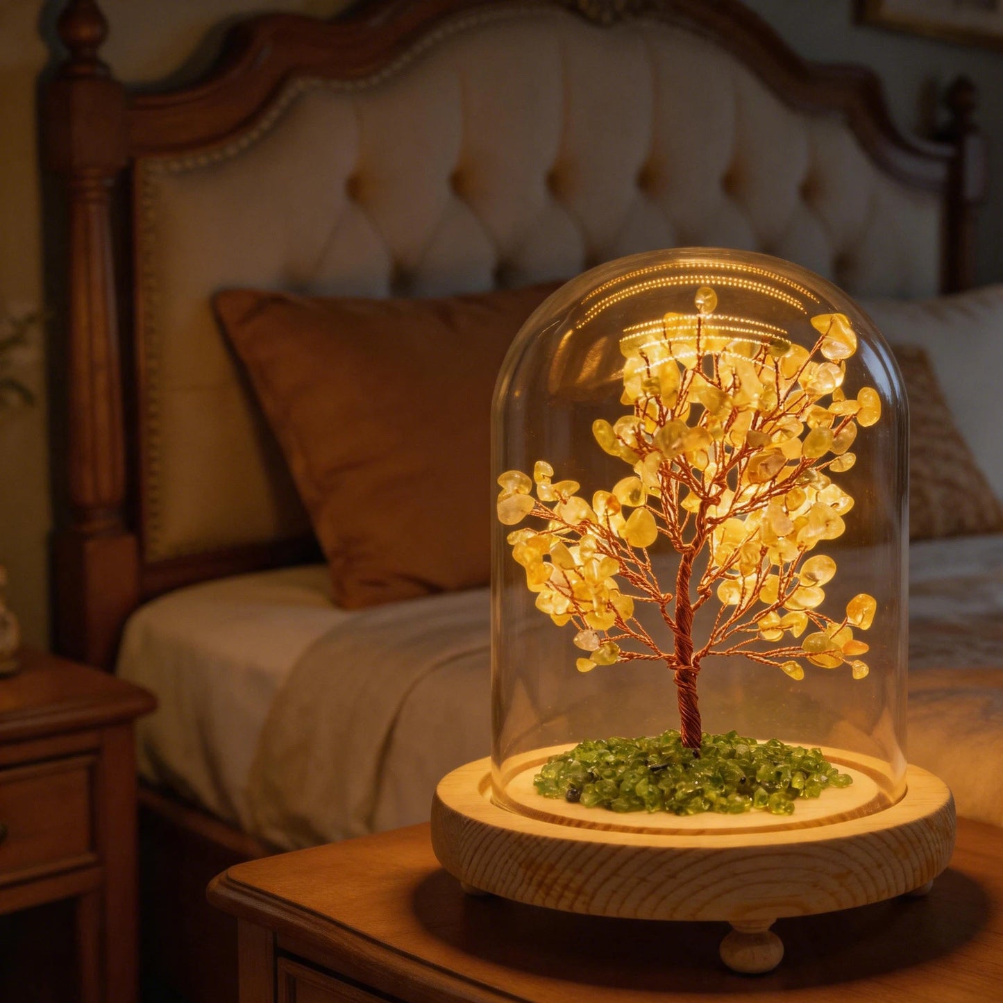 Close-up of citrine crystal tree in glass dome lamp, copper wire branches, glowing wooden base for feng shui decor.