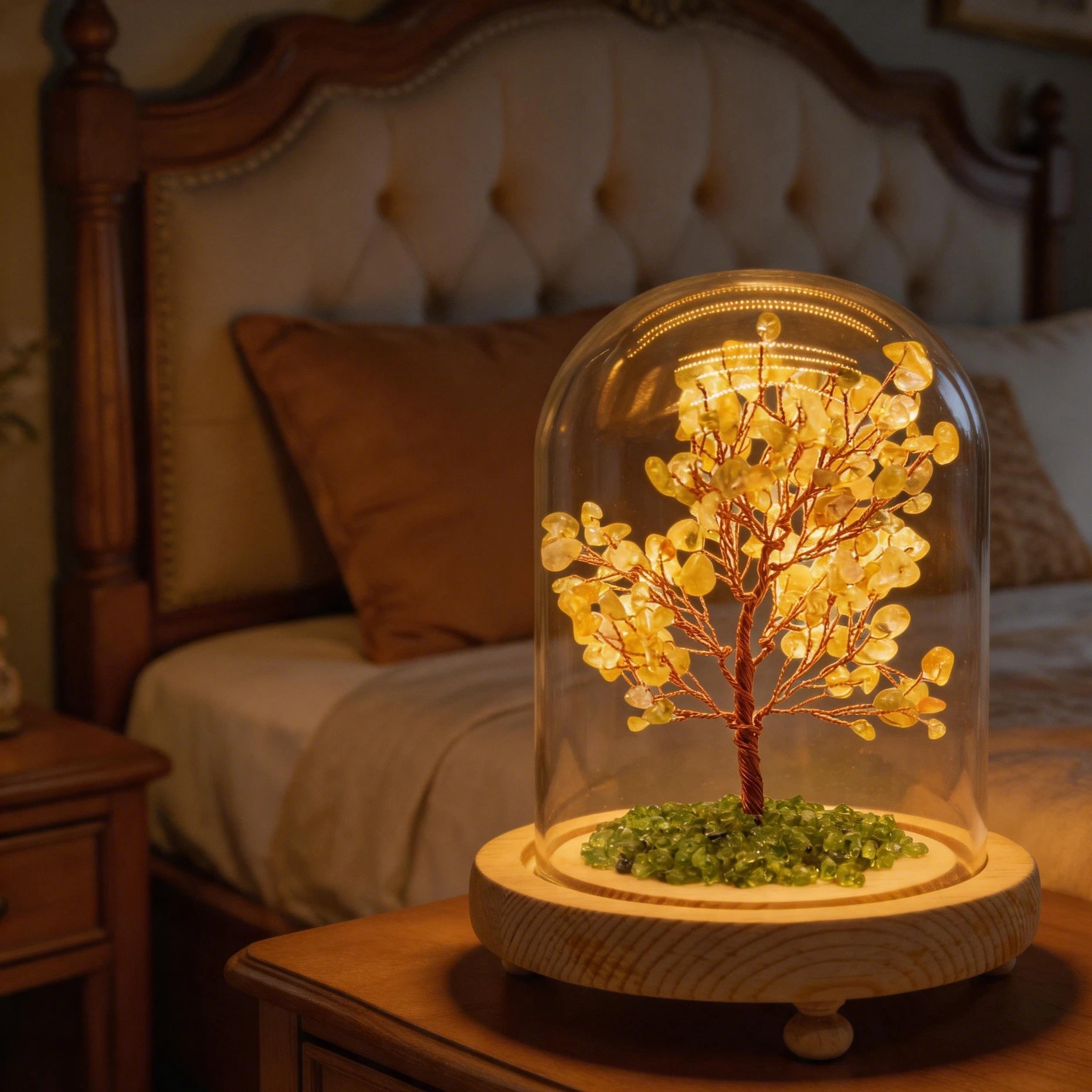 Close-up of citrine crystal tree in glass dome lamp, copper wire branches, glowing wooden base for feng shui decor.