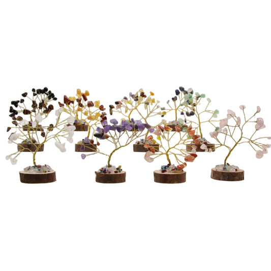 Set of 7 mini crystal tree of life decor pieces with natural wood bases, featuring various healing gemstones on a white background.