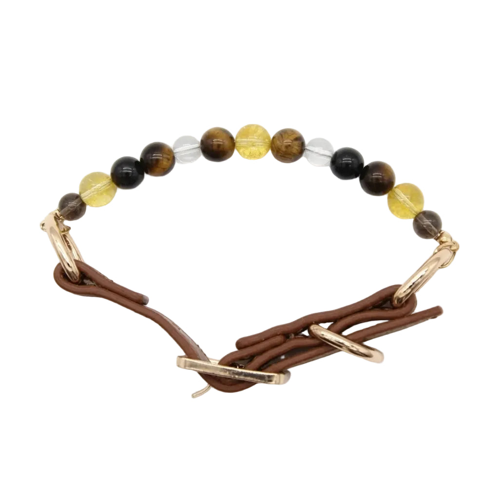 Close-up of natural healing crystal bead strand on leather dog collar showing golden tiger's eye, yellow citrine, black obsidian, and clear quartz stones with gold D-ring attachment detail